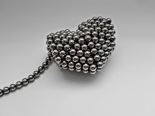 Neocube magnetic balls gray color heart made on white background. Children's magnetic toy
