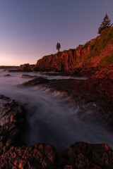 Fototapeta na wymiar Water flowing between rock formation on the shore.