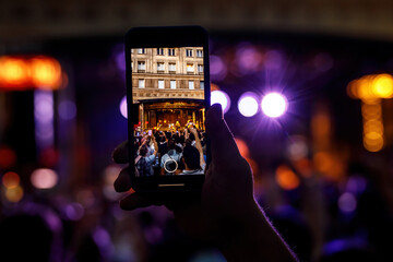 Fototapeta na wymiar People holding their smartphones at concert and taking pictures.