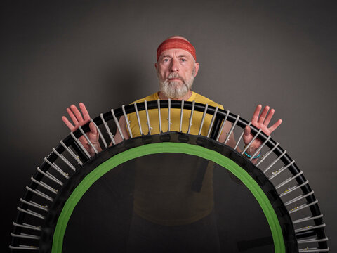 senior man with mini trampoline for fitness exercise and rebounding