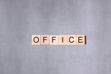 The word "Office" written in tile letters isolated on a grey background.
