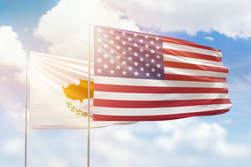 Sunny blue sky and flags of united states of america and cyprus