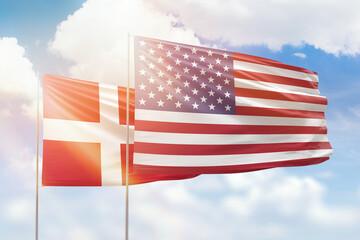 Sunny blue sky and flags of united states of america and denmark