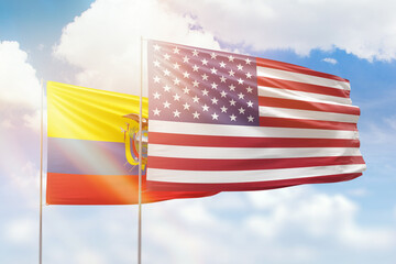 Sunny blue sky and flags of united states of america and ecuador