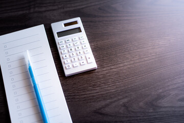 There is check list and calculator on the desk.