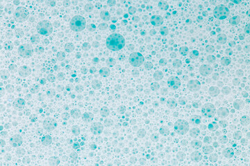 Blue water with white foam bubbles.Cleanliness and hygiene background.foam bubbles. Foam Water Soap...