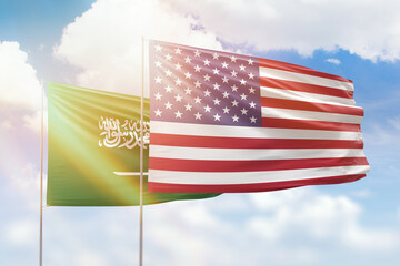 Sunny blue sky and flags of united states of america and saudi arabia