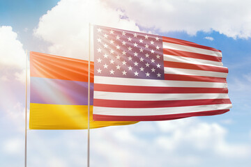 Sunny blue sky and flags of united states of america and armenia