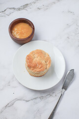 Homemade sweet scones on plate under morning sunlight. Fresh yummy tasty delicious English pastry for afternoon