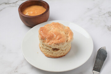 Homemade sweet scones on plate under morning sunlight. Fresh yummy tasty delicious English pastry for afternoon