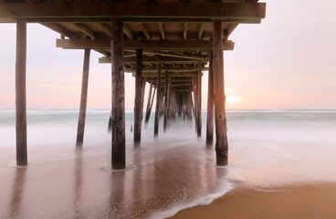 Beautiful sunrise at Nags Head Pier, Outer Banks, North Carolina, USA.  Nags Head is one of the...