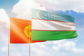 Sunny blue sky and flags of uzbekistan and kyrgyzstan