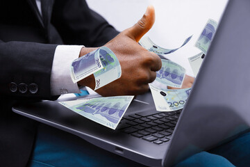200 Bosnia and Herzegovina convertible mark notes coming out of laptop with Business man giving thumbs up, Financial concept. Make money on the Internet, working with a laptop - obrazy, fototapety, plakaty