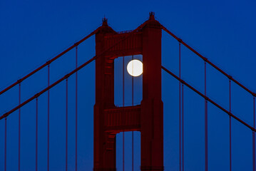 Fototapeta premium Full Moon June 2022 San Francisco Golden Gate Bridge Through North Tower Shot From Marin Headlands