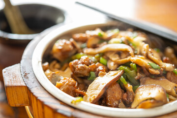 angle view fast food of fried chicken with slices of mushrooms with bowl of soup at horizontal composition