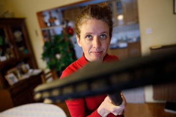 Confident Mid Adult Woman Goes on a Spider with an Electric Vacuum Cleaner