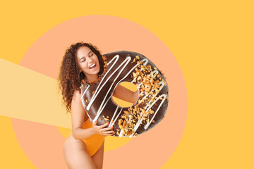 Beautiful young African-American woman with big tasty donut on color background