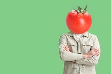 Man with fresh tomato instead of his head on green background