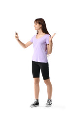 Teenage girl using mobile phone on white background