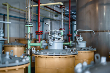 Modern sand and coal filtration columns with red pipelines