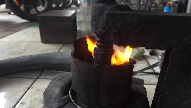 Traditional pressing machine for patching tires in workshop