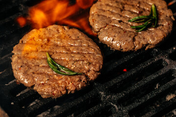 Beef steaks pieces of meat on the grill with flames. American cuisine. The concept cooking meat. Food recipe background. Close up. place for text