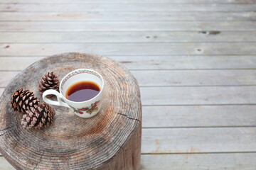 Pinecones and tea  on stump