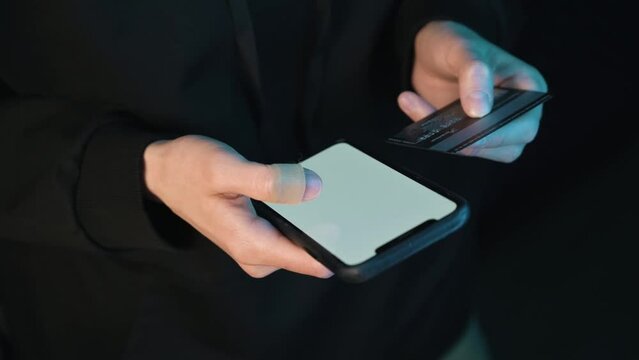 Person is typing in credit card information on a smartphone.