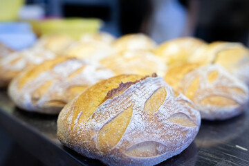 A finished batch of artisan wheat bread, just out of the oven. Front view.
