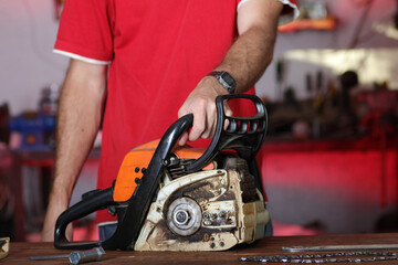 chainsaw on a table in a garage