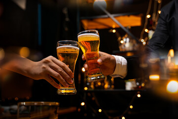 food and drink male friends are happy drinking beer and clinking glasses at a bar or pub.