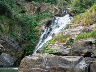 Fototapeta na wymiar Beautiful view of the Ravana Ella waterfall, 25 meters high. Ella, Sri Lanka