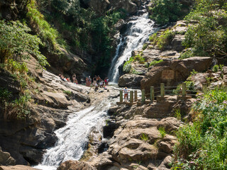Ella, Sri Lanka - March 9, 2022: Beautiful view of the Ravana Ella waterfall, 25 meters high. People came to the waterfall and admire nature