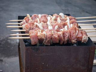 Shashlik is fried on the grill. Food is cooked outside.