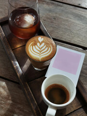a cup of latte art coffee on wooden background                                                                                                                                                          