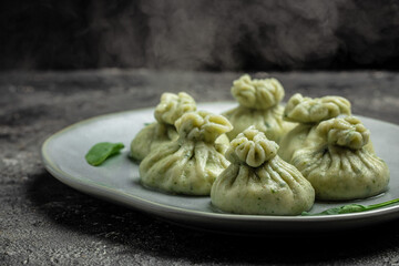 Hot steam Khinkali with cheese and spinach dumplings. cooking khinkali. National Georgian cuisine. banner, menu, recipe place for text