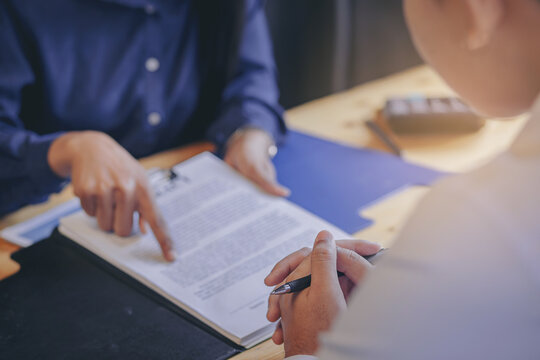 Businesswoman reading documents at meeting, business partner considering contract terms before signing checking legal contract law conditions. Selected focus