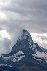 Fototapeta na wymiar Beautiful cloudscape in the Swiss Alps in summer, with Matterhorn peak in the background