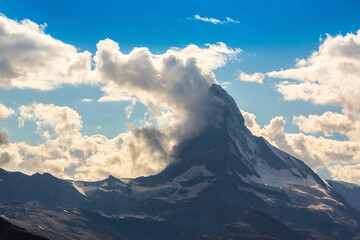 Beautiful cloudscape in the Swiss Alps in summer, with Matterhorn peak in the background