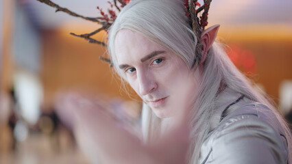 Elven king cosplay inviting pose for camera at comic con