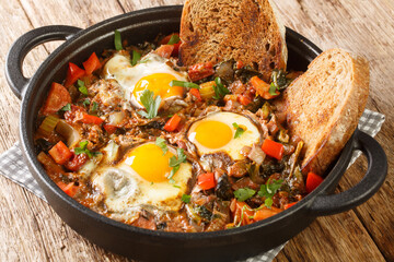 Acquacotta is a delicious tuscan soup originally from Maremma close up in the pot on the wooden table. Horizontal