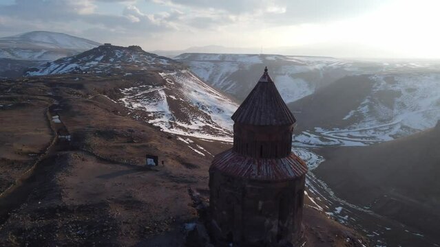 Kars, Turkey - February 23, 2022: Aerial drone footage of Saint Gregory church with a bird on top of it at Ani ancient city Kars Turkey