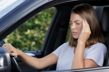 Fototapeta na wymiar stressed woman driver sitting inside her car