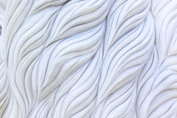 Marble surface is carved with swaying patterns.