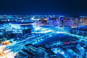 Fototapeta na wymiar Aerial view of the night modern city and stadium. Bright lights of the night streets. Ekaterinburg. Russia