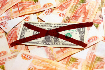 Crossed out dollar bill against the background of five thousandth banknotes of the ruble. Sanction concept, dollar ban, import export crisis. Import substitution. - obrazy, fototapety, plakaty
