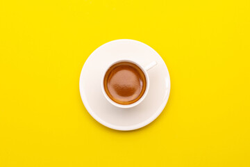 Top view espresso coffee in white cup on yellow.