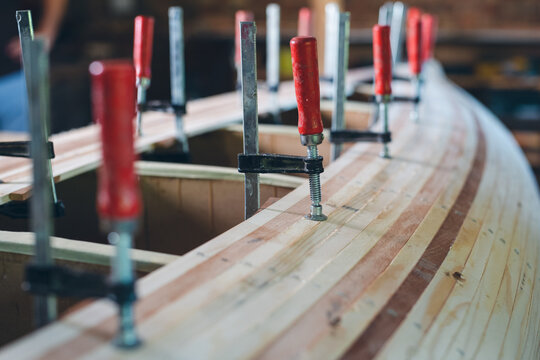 Carpenter assembling new wooden canoe of their own design