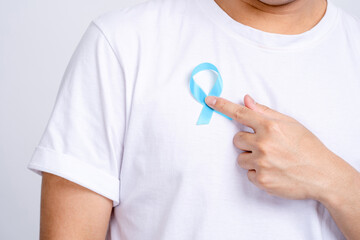 Medicine, Healthcare - Close-up of a man's hand pointing to a blue prostate prostate cancer...