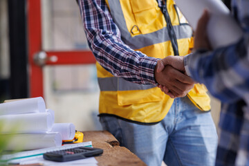 Architect contractor shaking hands with client after seal a deal to renovate building, engineer...